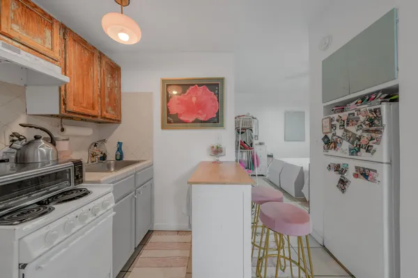a kitchen with stainless steel appliances granite countertop a refrigerator and a stove