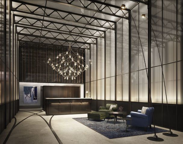 a living room with a couch and a chandelier