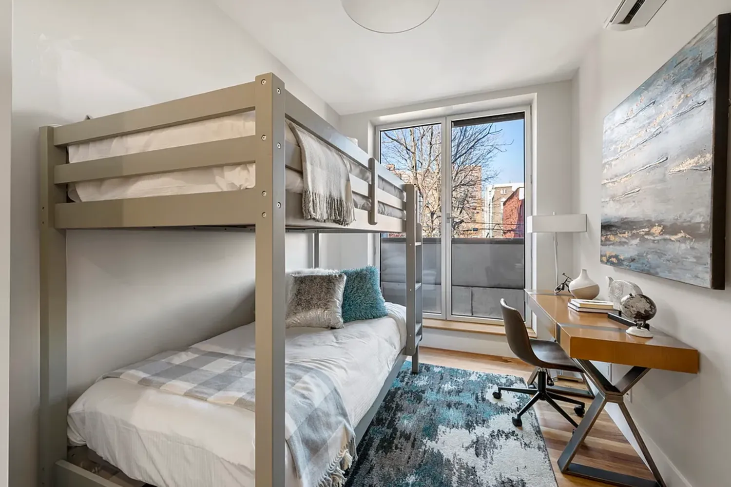 a bedroom with a bed and large windows