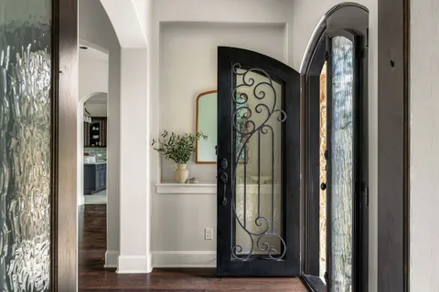 a kitchen with a table chairs and refrigerator