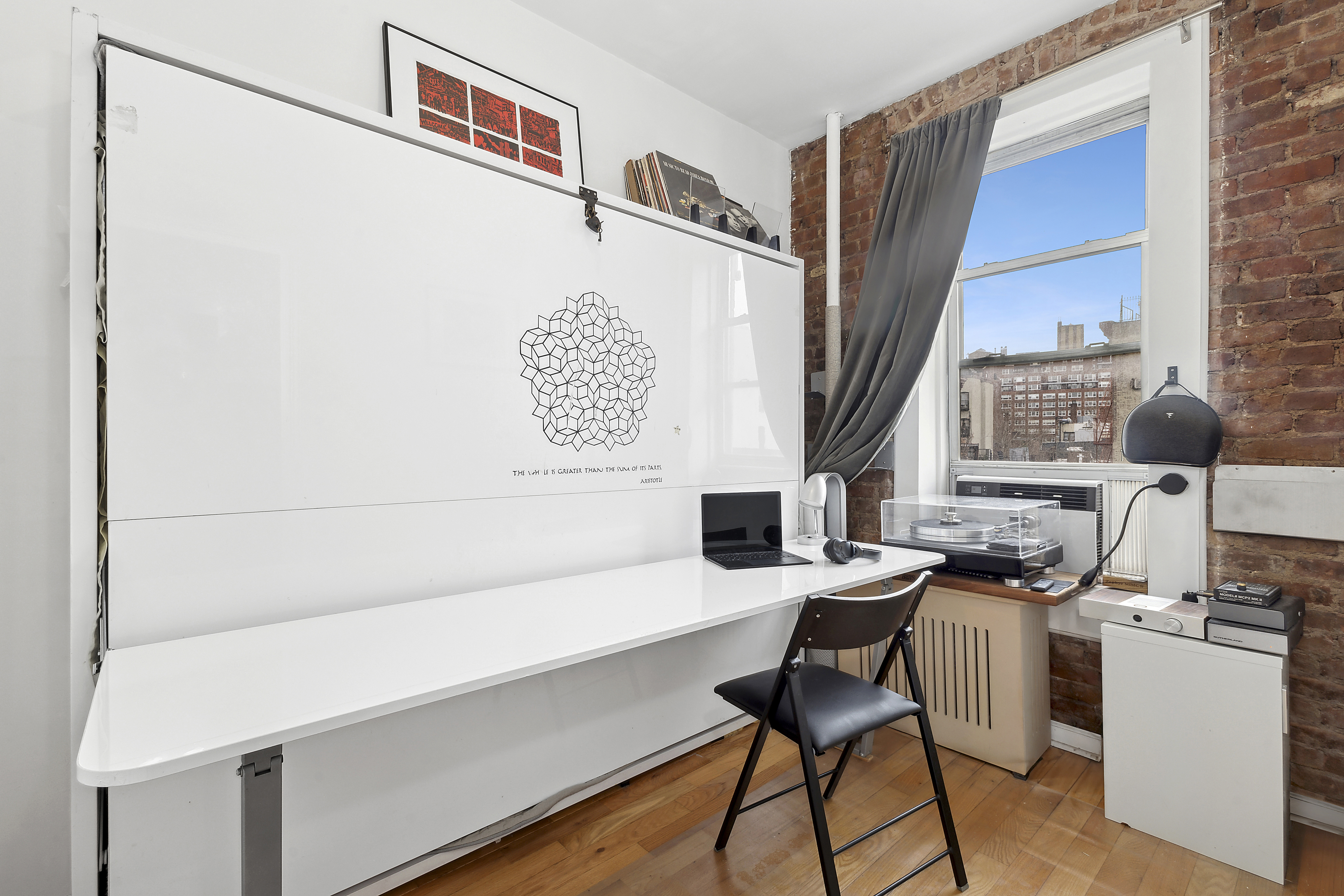 124 Thompson Street, Unit 21 Manhattan, NY 10012 - Photo 5 of 10 a view of a workspace with furniture and a window