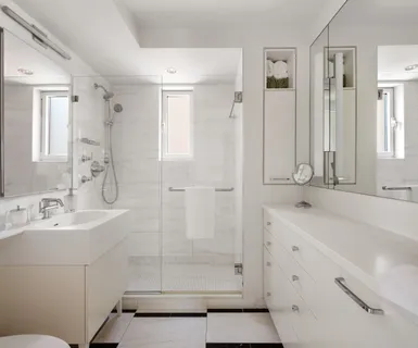 a bathroom with a shower sink and mirror