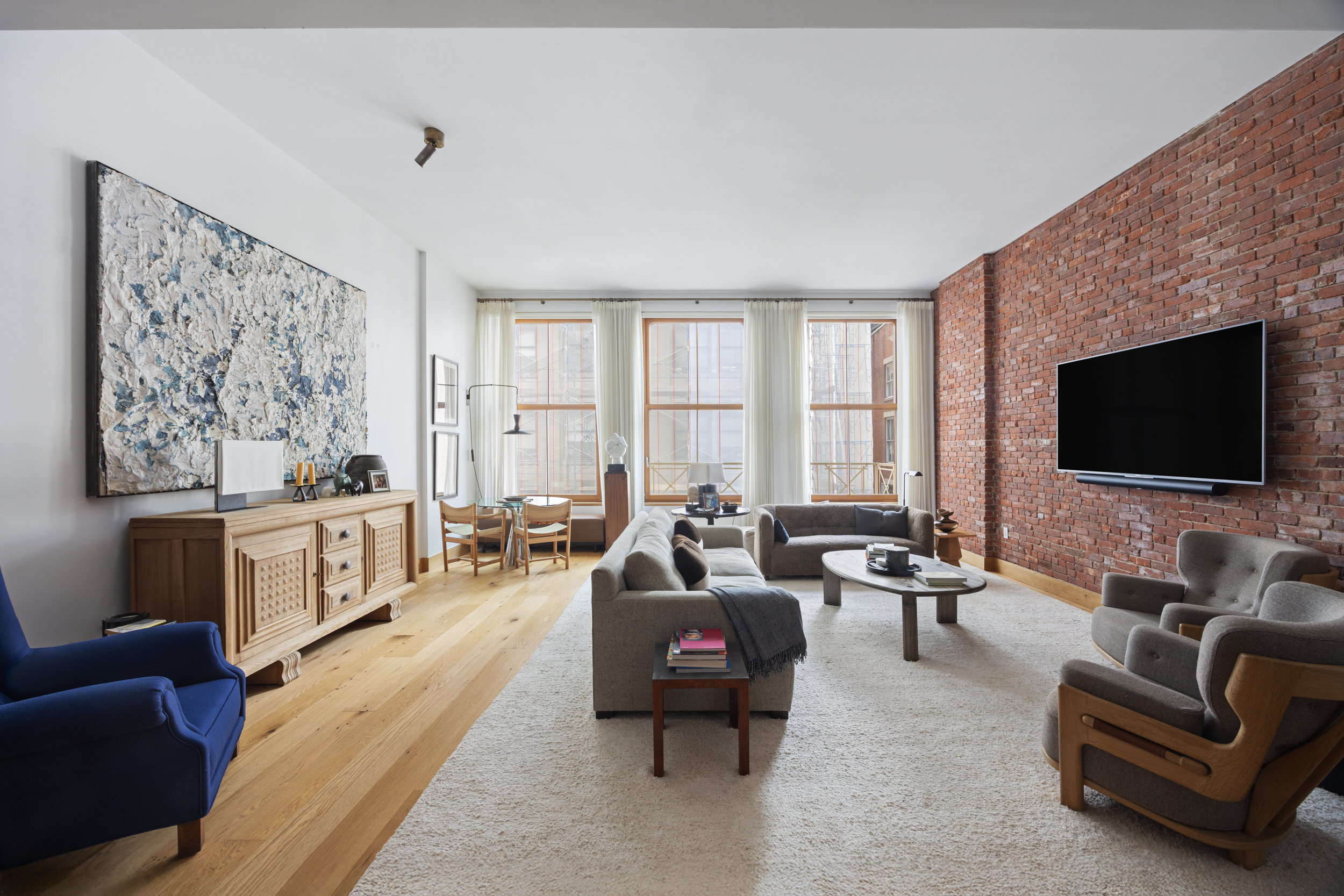 a living room with furniture fireplace and flat screen tv