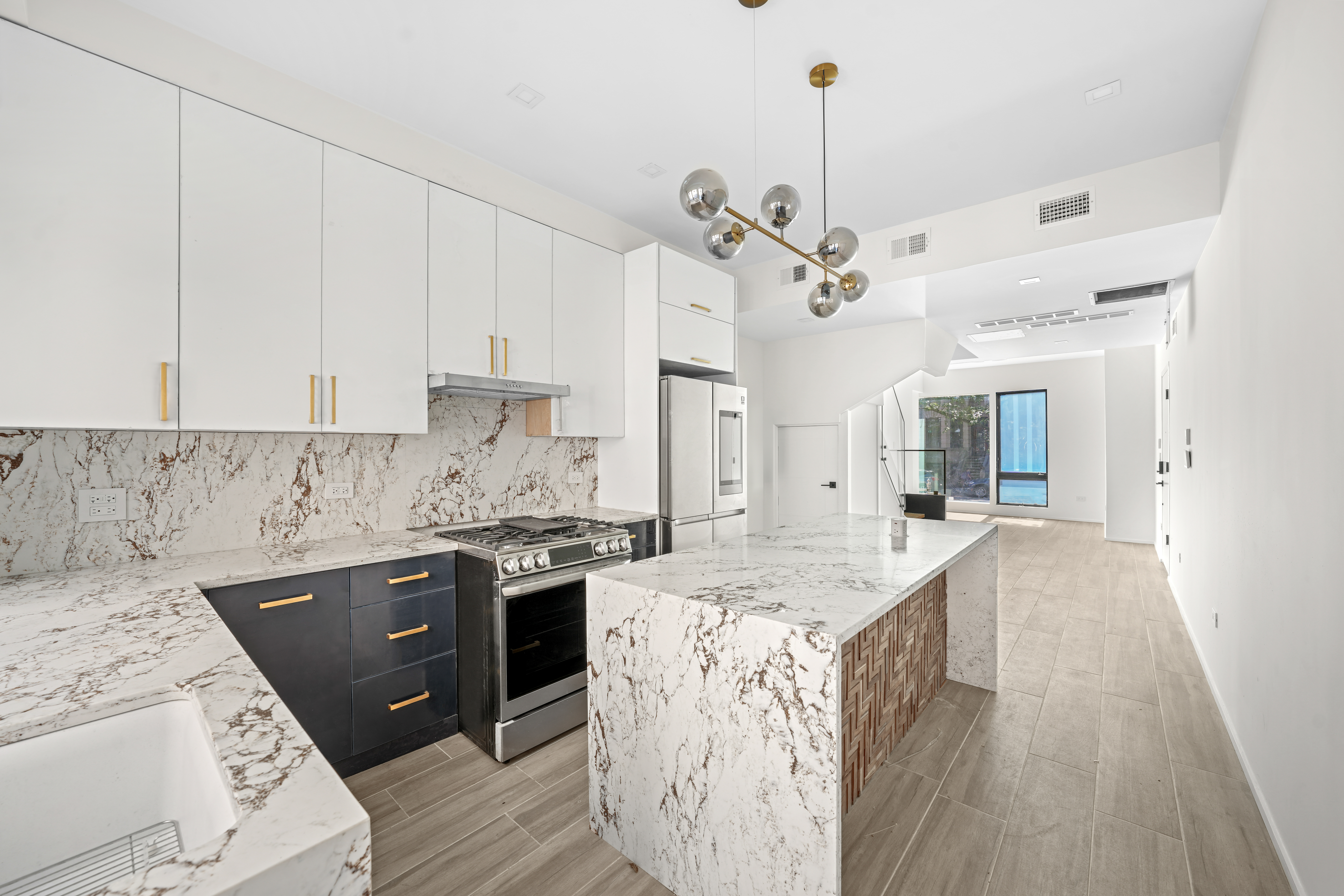 a kitchen with a stove sink and cabinets