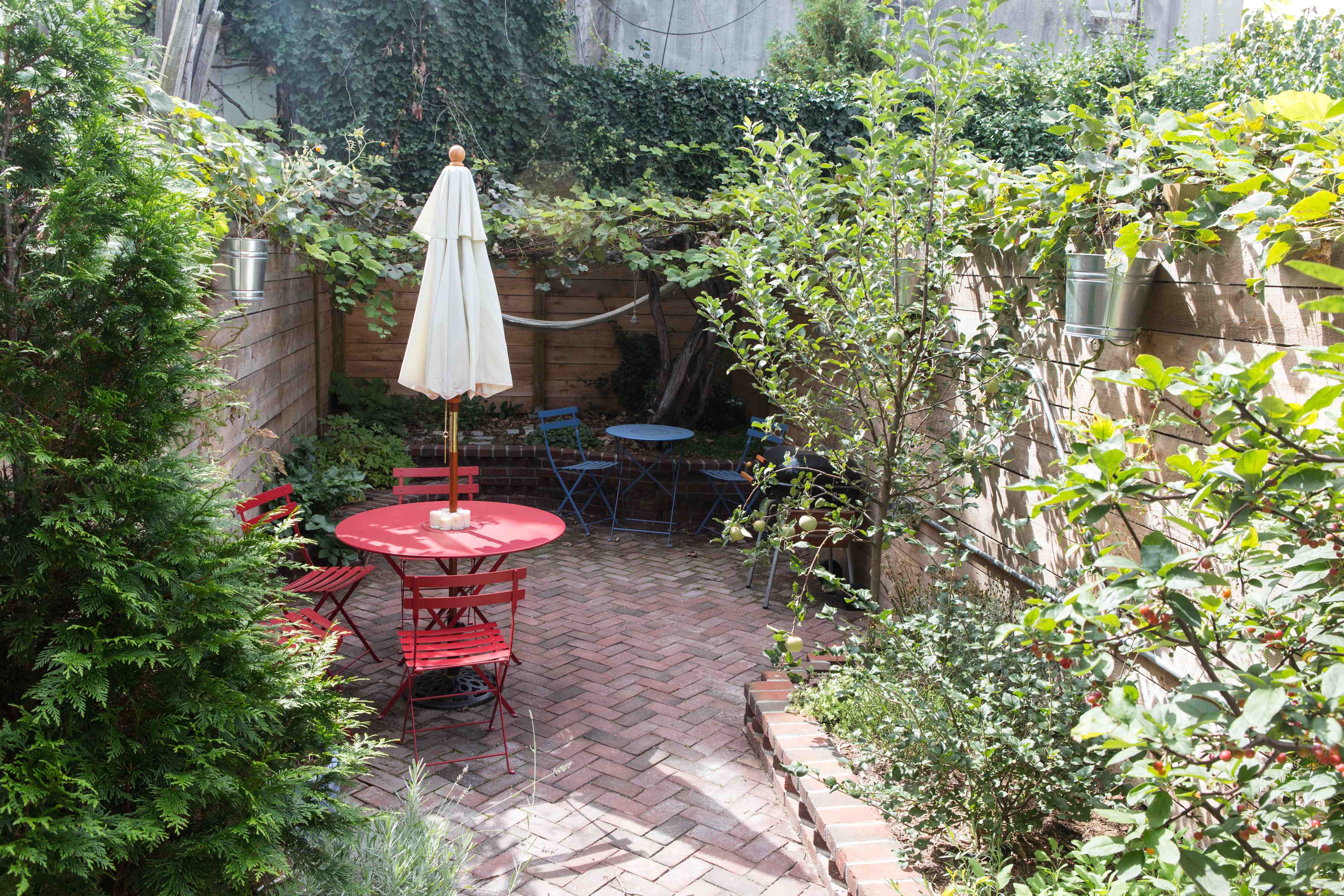 162 10th Street Brooklyn, NY 11215 - Photo 5 of 13 a view of a backyard with table and chairs and potted plants