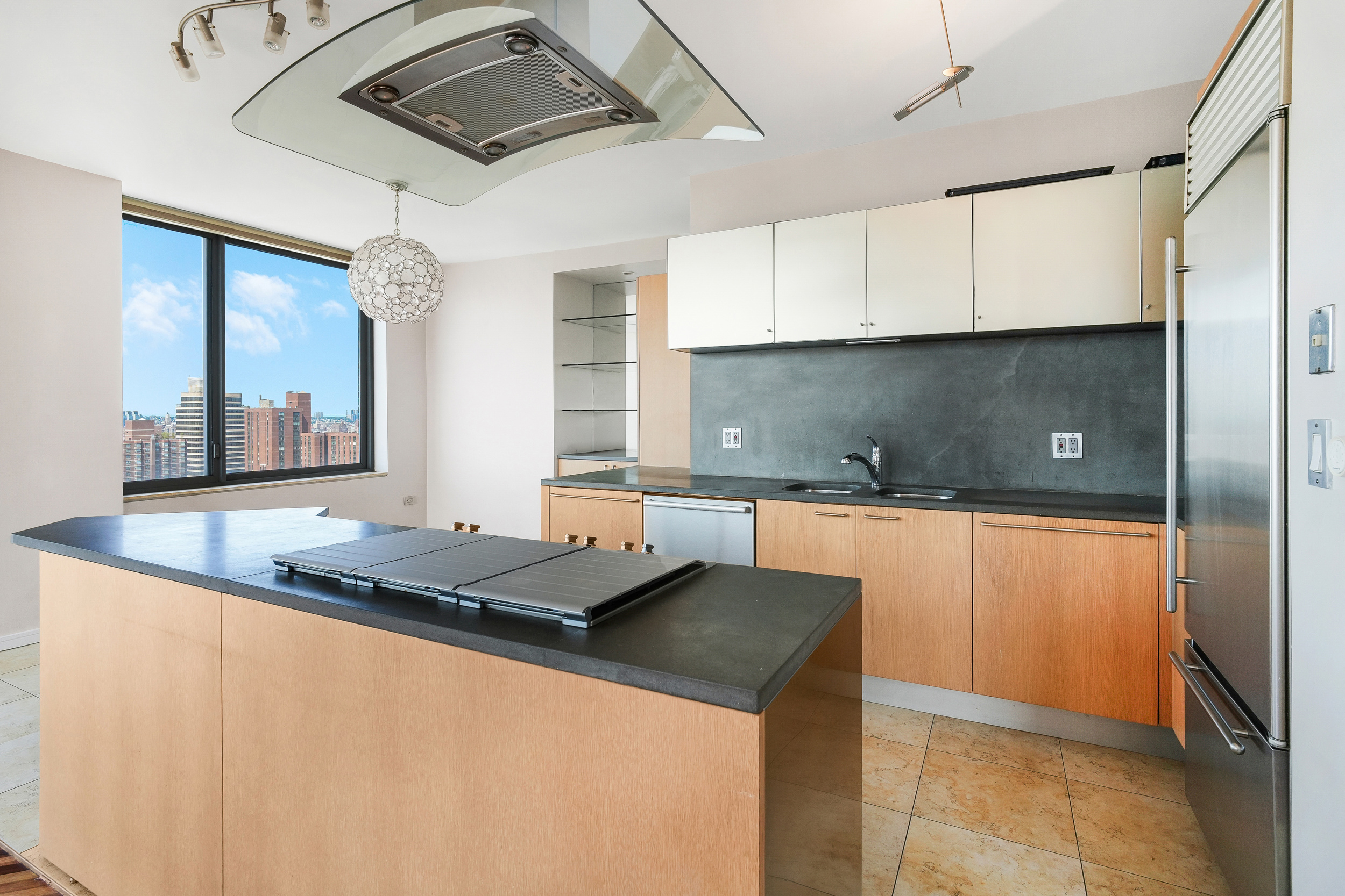 360 East 88th Street, Unit 34A Manhattan, NY 10128 - Photo 5 of 35 a kitchen with stainless steel appliances granite countertop a sink and a stove