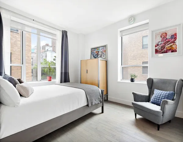 a bedroom with a bed and a couch