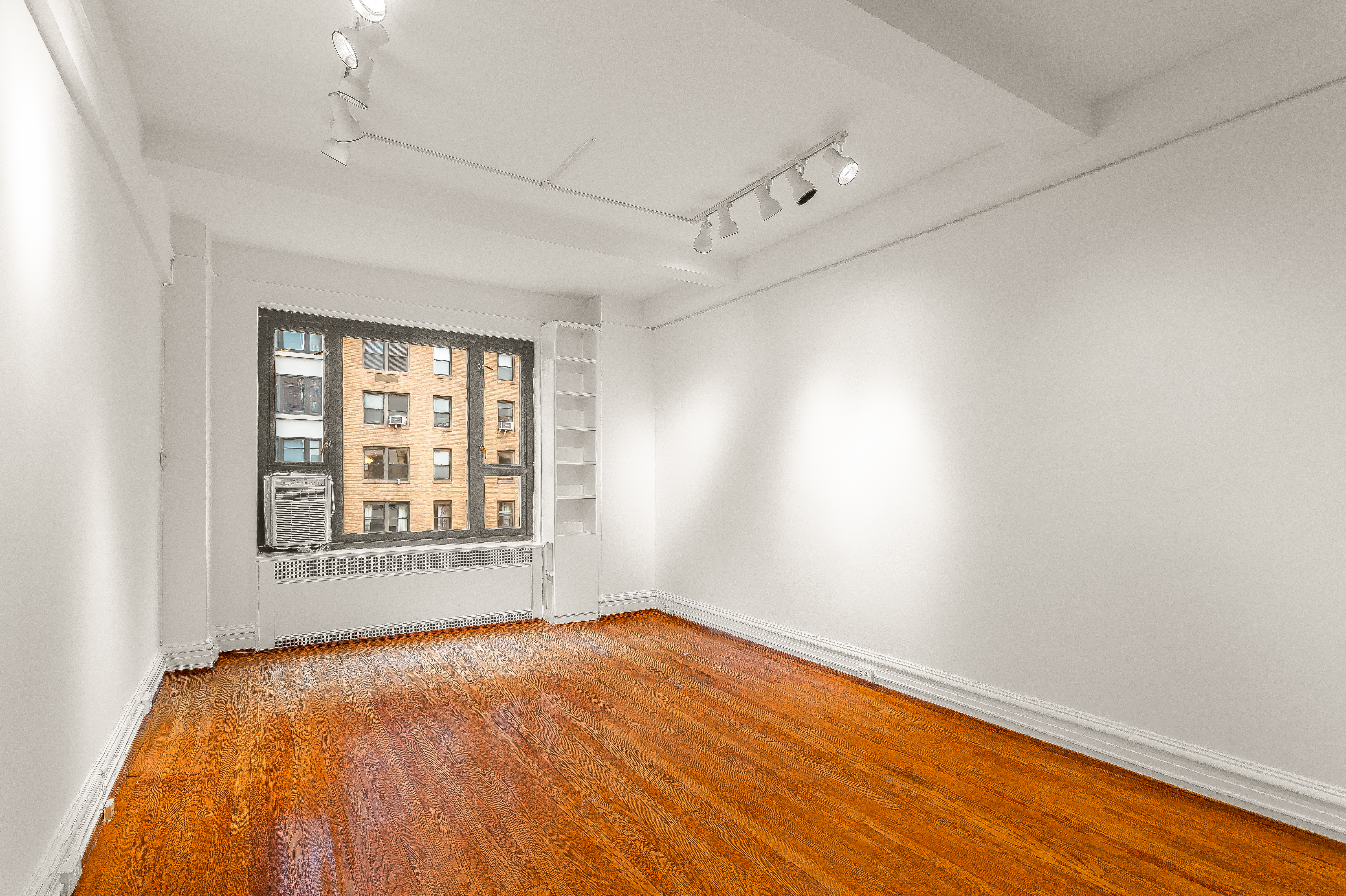 180 East 79th Street, Unit 5A Manhattan, NY 10075 - Photo 12 of 19 an empty room with a window
