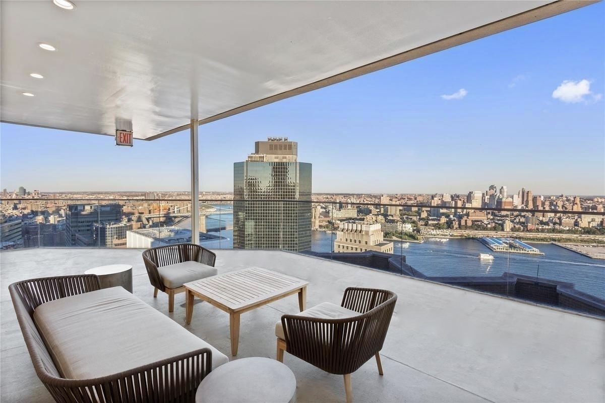75 Wall Street, Unit 36F Manhattan, NY 10005 - Photo 11 of 15 a view of a balcony with furniture and a view of lake