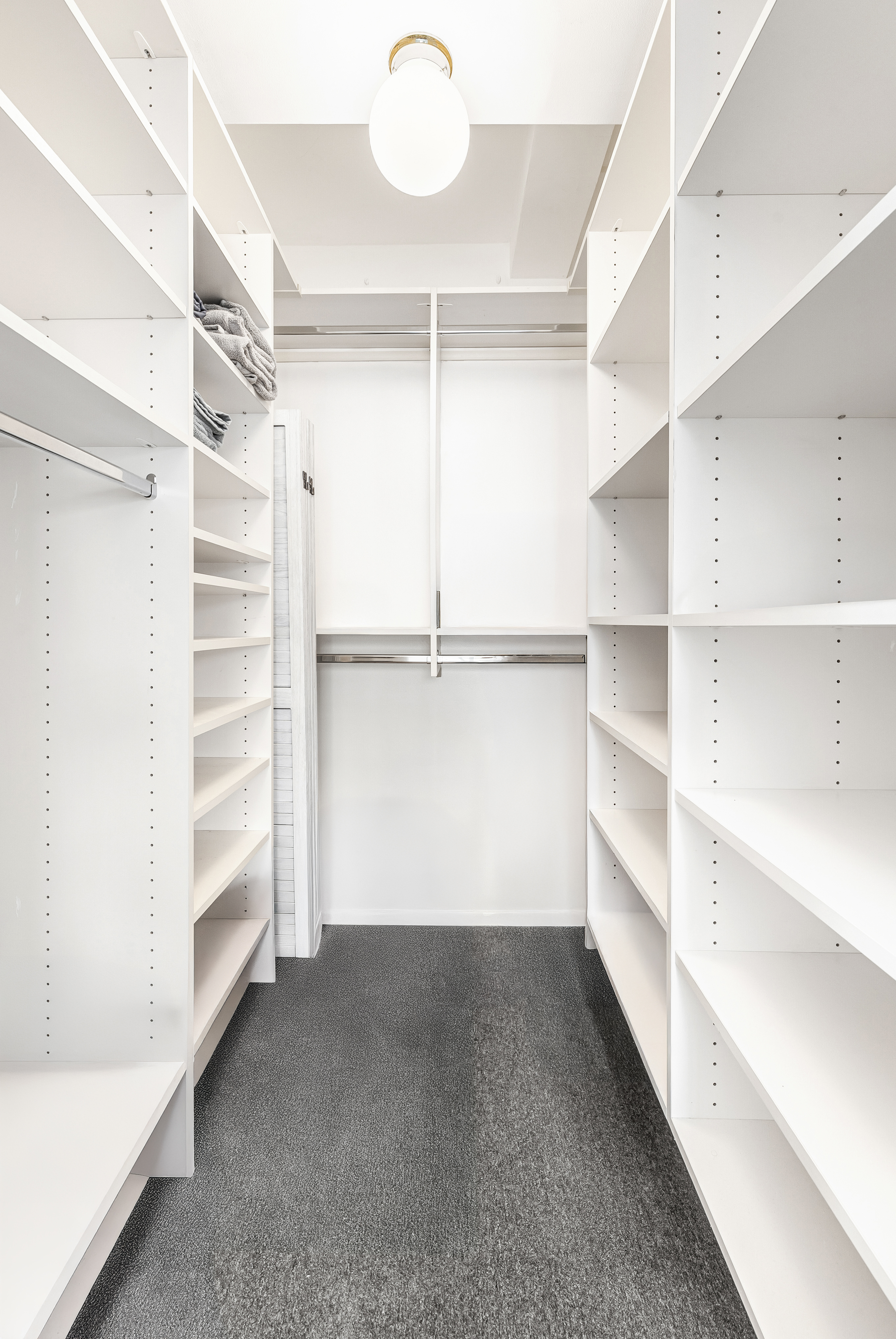 235 East 49th Street, Unit 6G Manhattan, NY 10017 - Photo 16 of 22 a view of walk in closet with empty racks