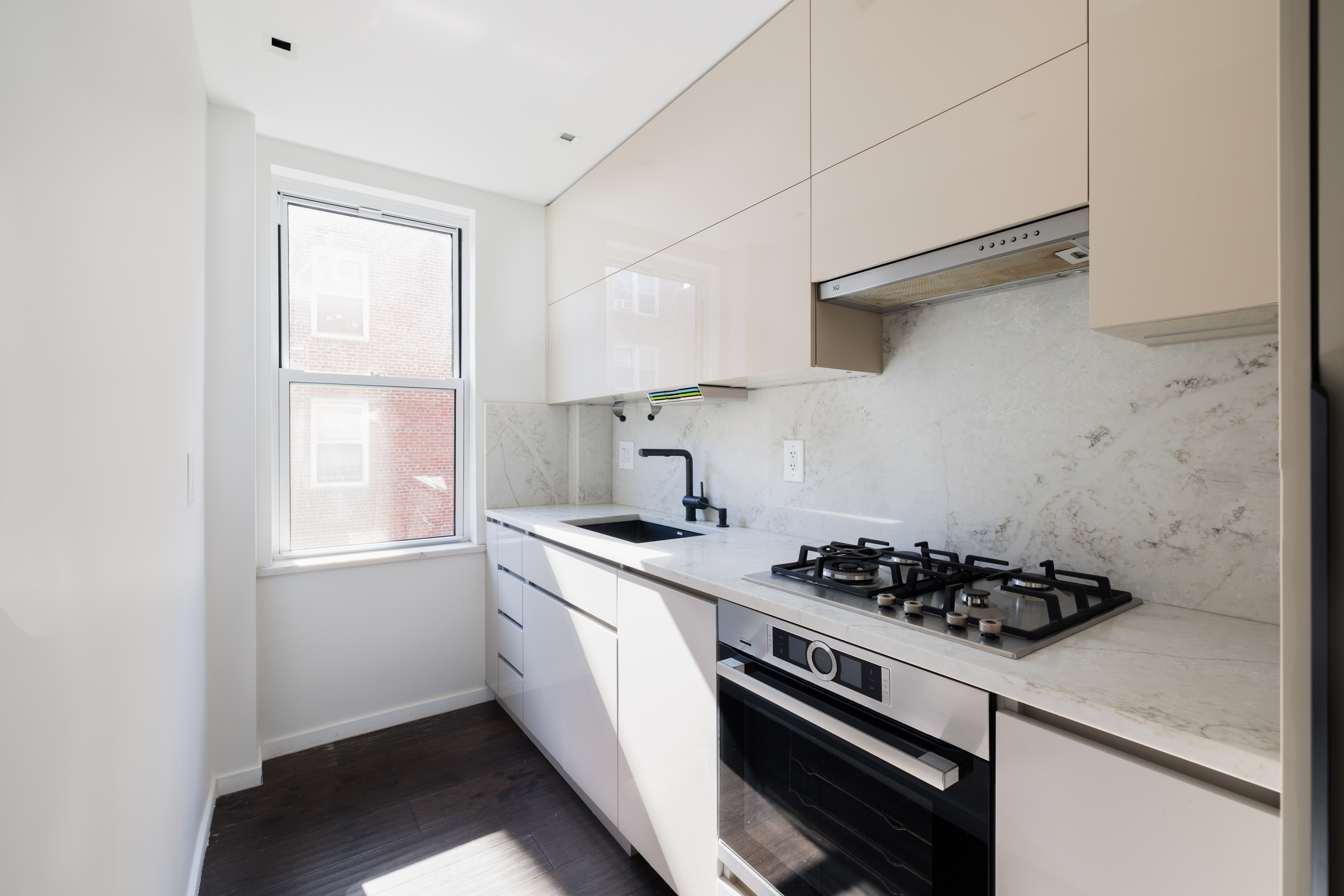 71-36 110th Street, Unit 4C Queens, NY 11375 - Photo 7 of 14 a kitchen with stainless steel appliances a stove a sink and white cabinets