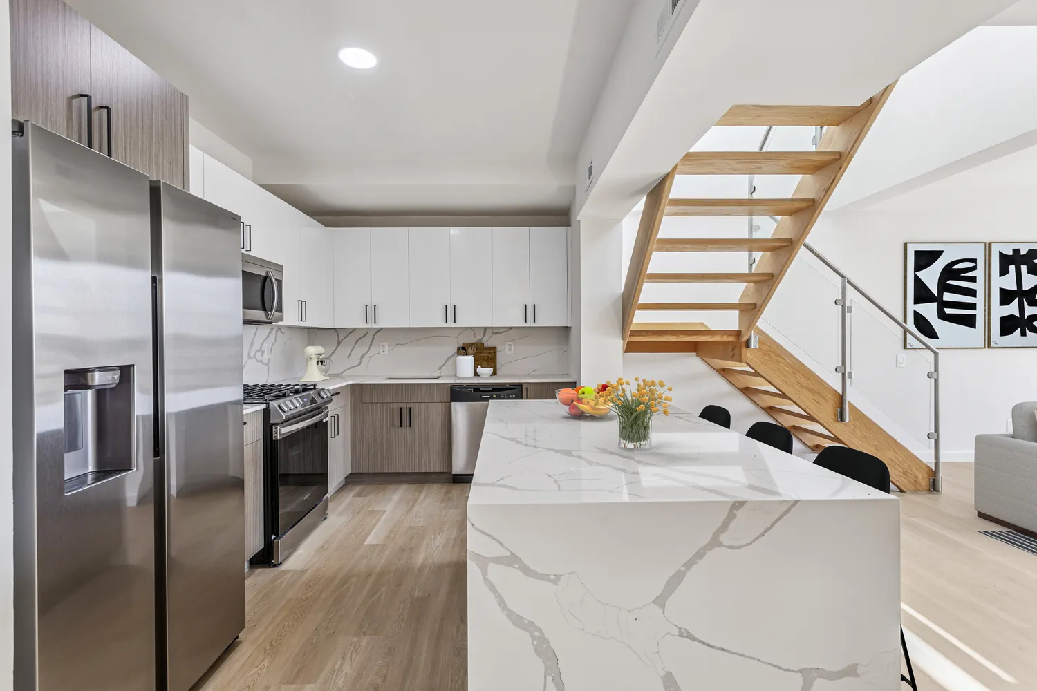 a kitchen that has a lot of cabinets a sink and appliances in it