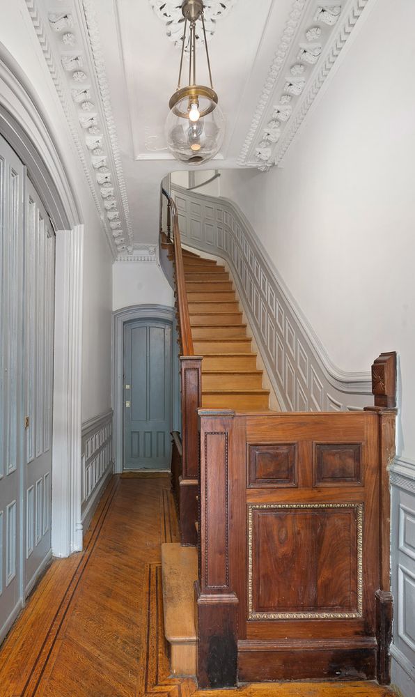 214 Carlton Avenue, Unit 2 Brooklyn, NY 11205 - Photo 12 of 16 a bedroom with a bed and a chandelier