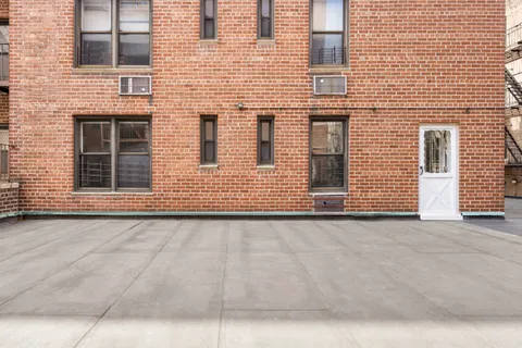 a view of a brick house with many windows