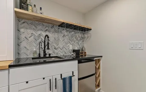 a view of a sink and a refrigerator