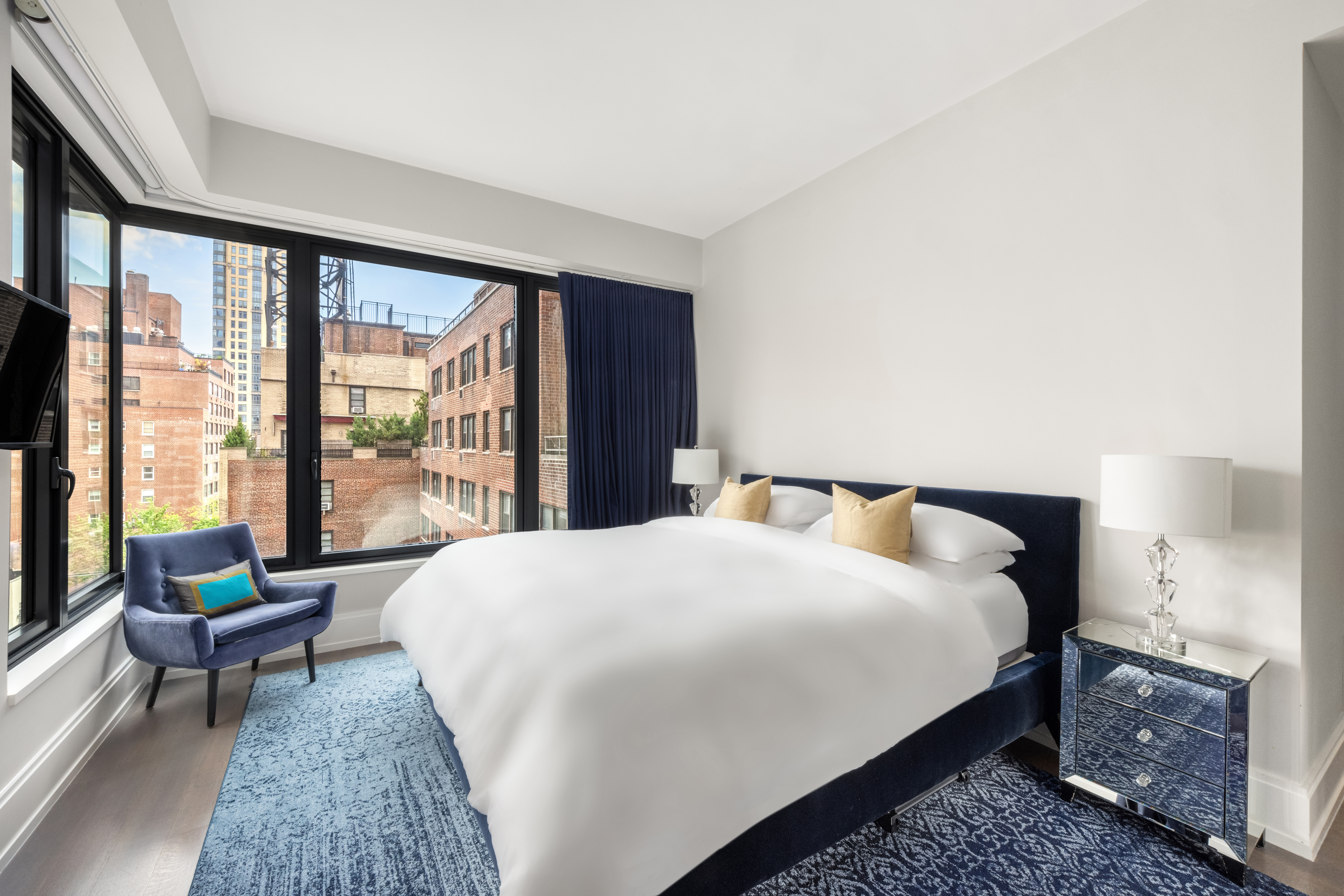 301 East 50th Street, Unit 8C Manhattan, NY 10022 - Photo 13 of 20 a bedroom with a bed and a large window