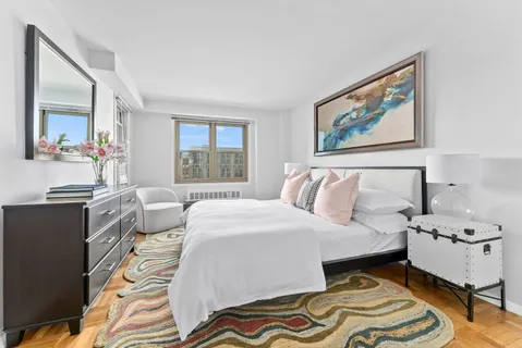 a spacious bedroom with a bed and a couch