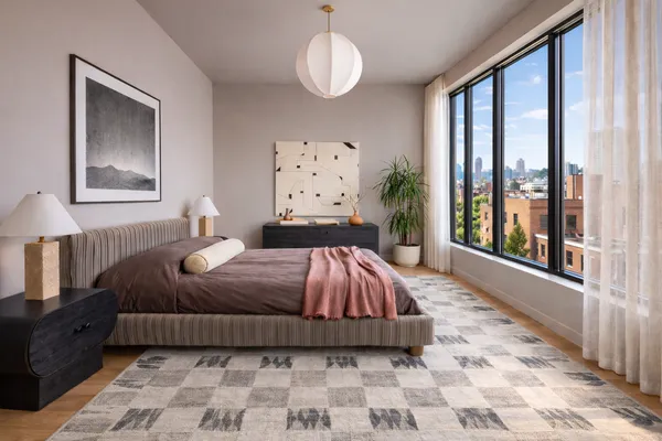 a bedroom with a bed and a window