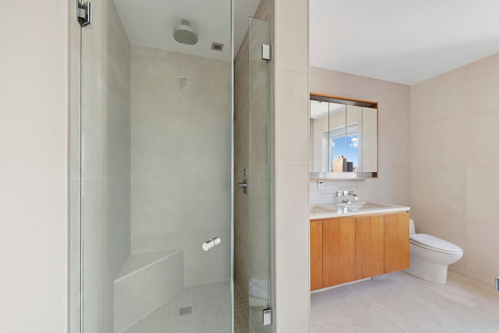 555 West 59th Street, Unit 25E Manhattan, NY 10019 - Photo 7 of 18 a bathroom with a toilet a sink and mirror