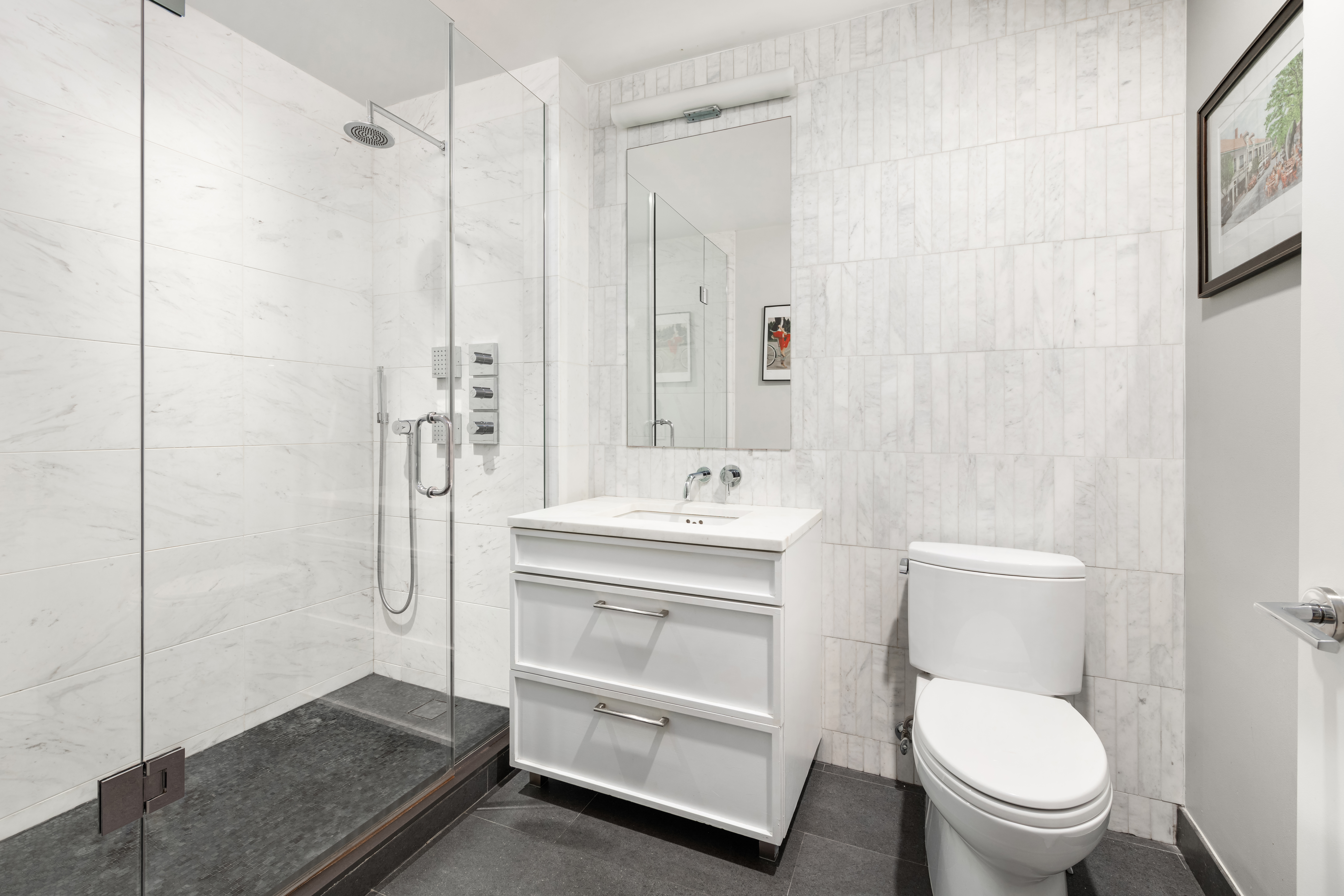 160 East 22nd Street, Unit 3A Manhattan, NY 10010 - Photo 5 of 7 a bathroom with a toilet a sink and shower