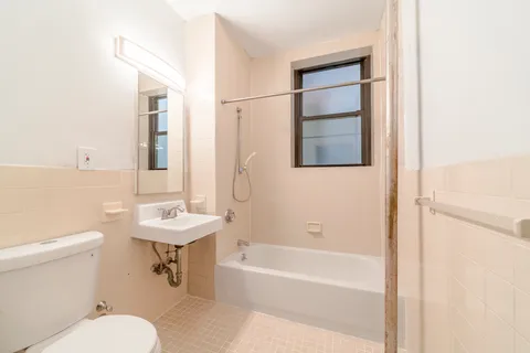 a bathroom with a toilet a sink and a bathtub