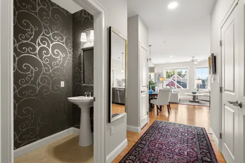 a view of a hallway to a livingroom with furniture
