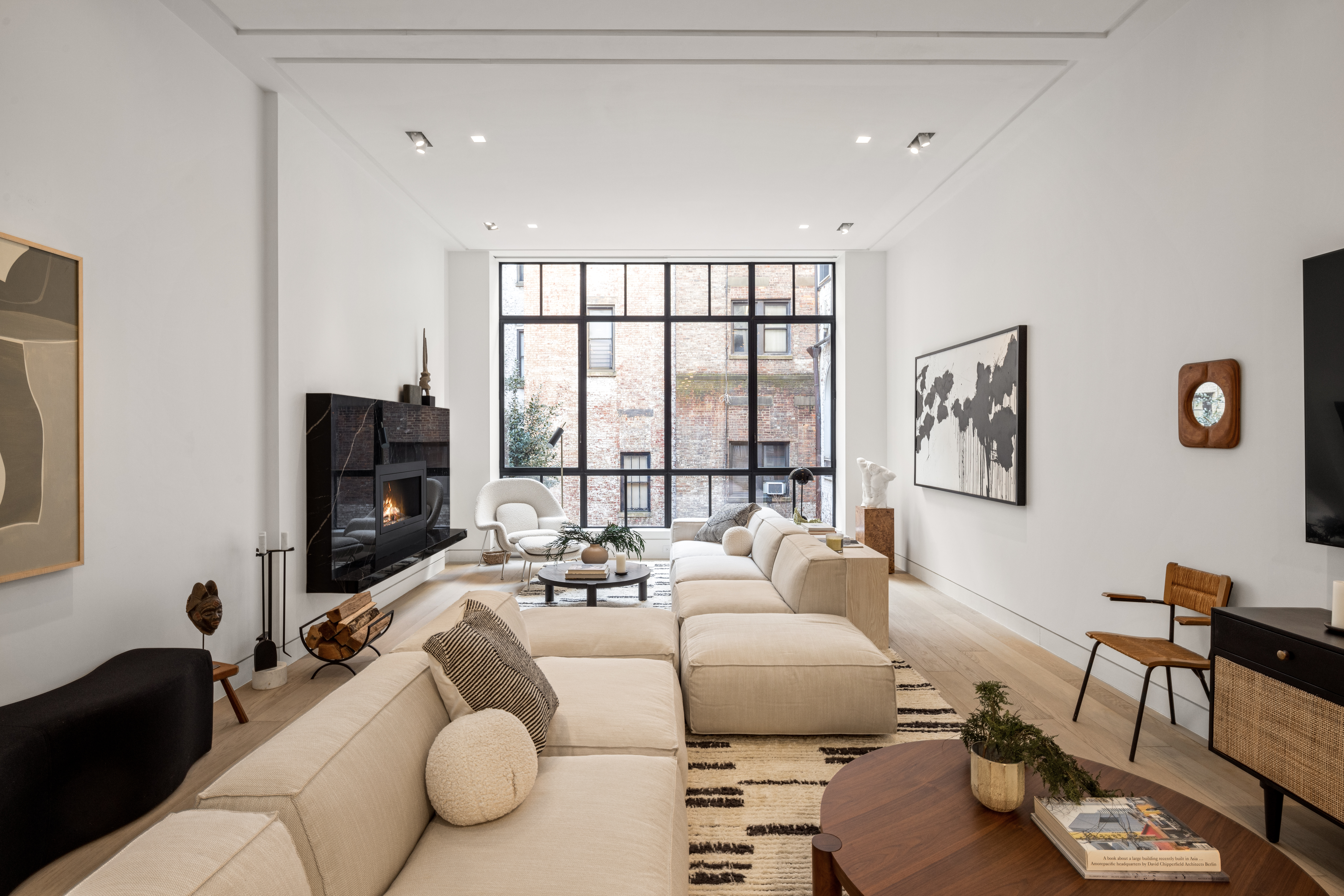 a living room with furniture large window and a flat screen tv