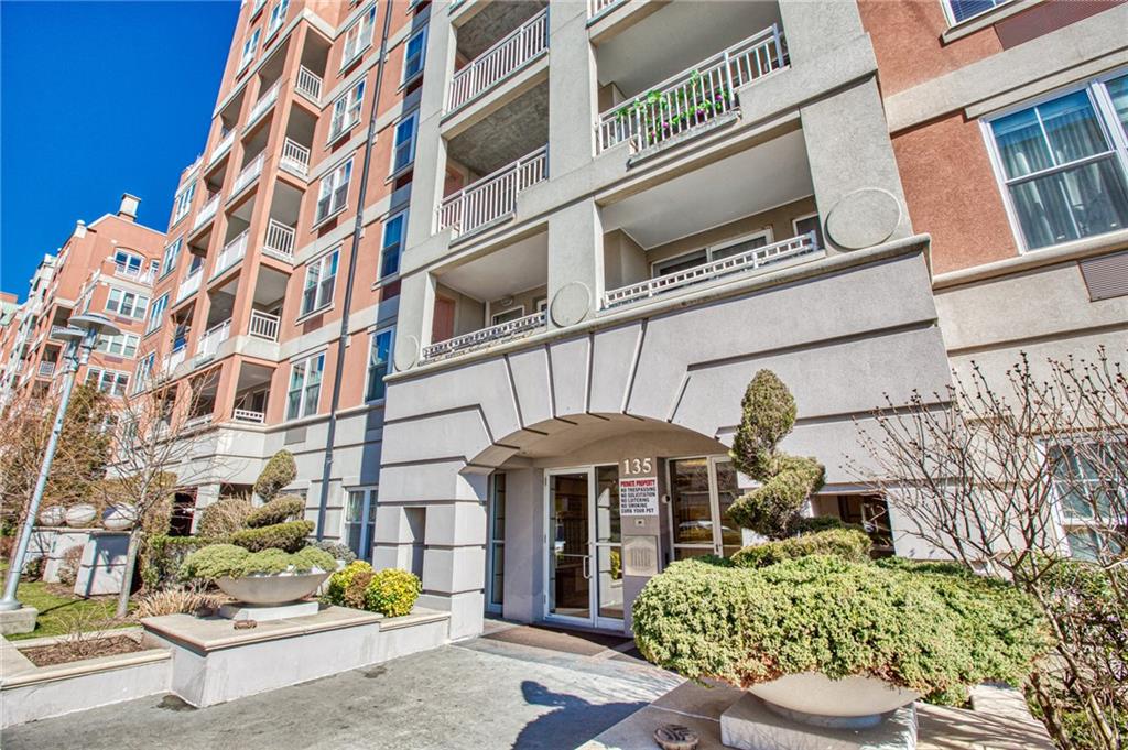135 Oceana Drive East, Unit 2C Brooklyn, NY 11235 - Photo 15 of 29 a front view of a building with a yard