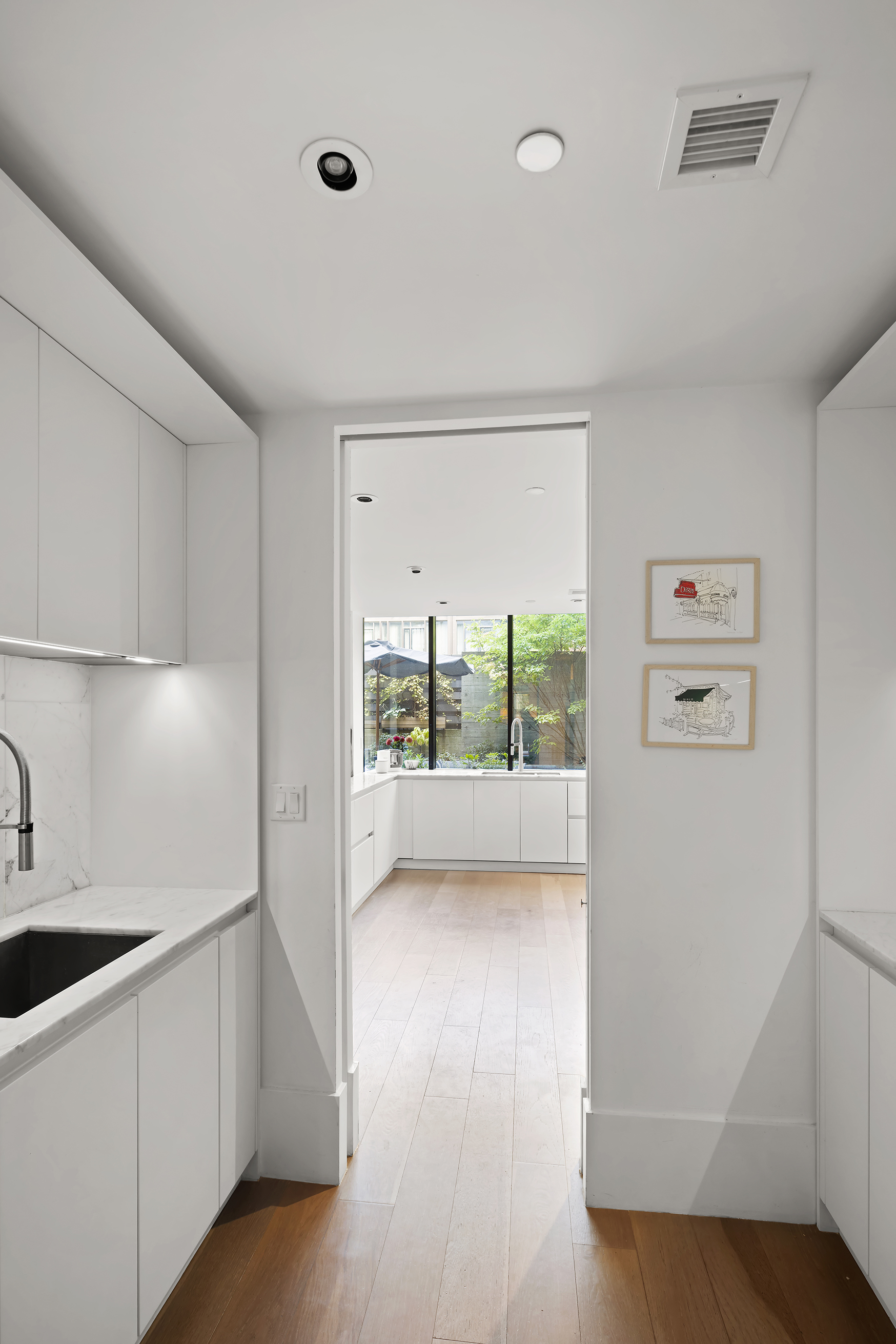 429 Kent Avenue, Unit TH2 Brooklyn, NY 11249 - Photo 11 of 34 a view of washer and dryer with kitchen in the background