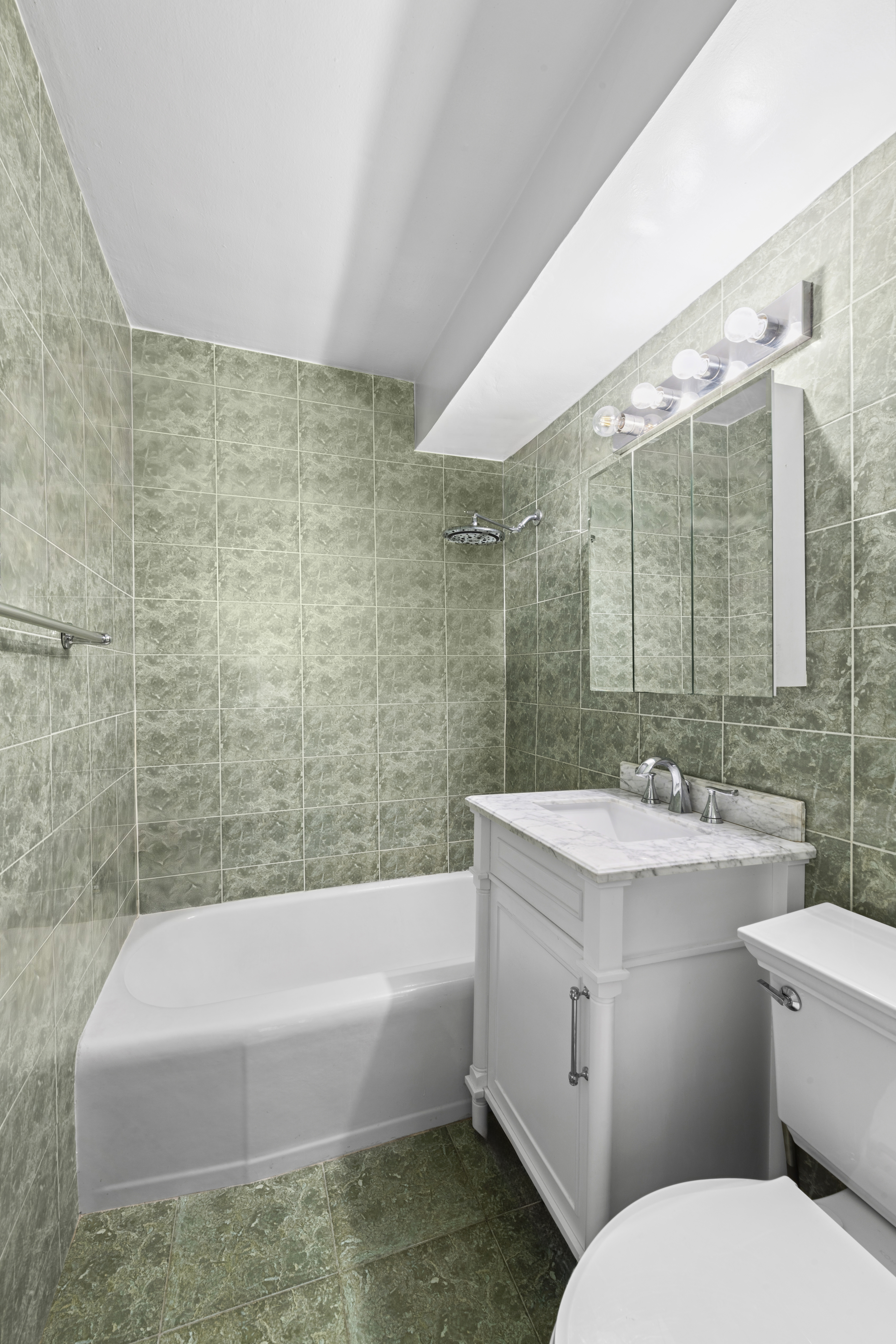 411 East 53rd Street, Unit 16B Manhattan, NY 10022 - Photo 5 of 9 a bathroom with a sink a toilet and shower
