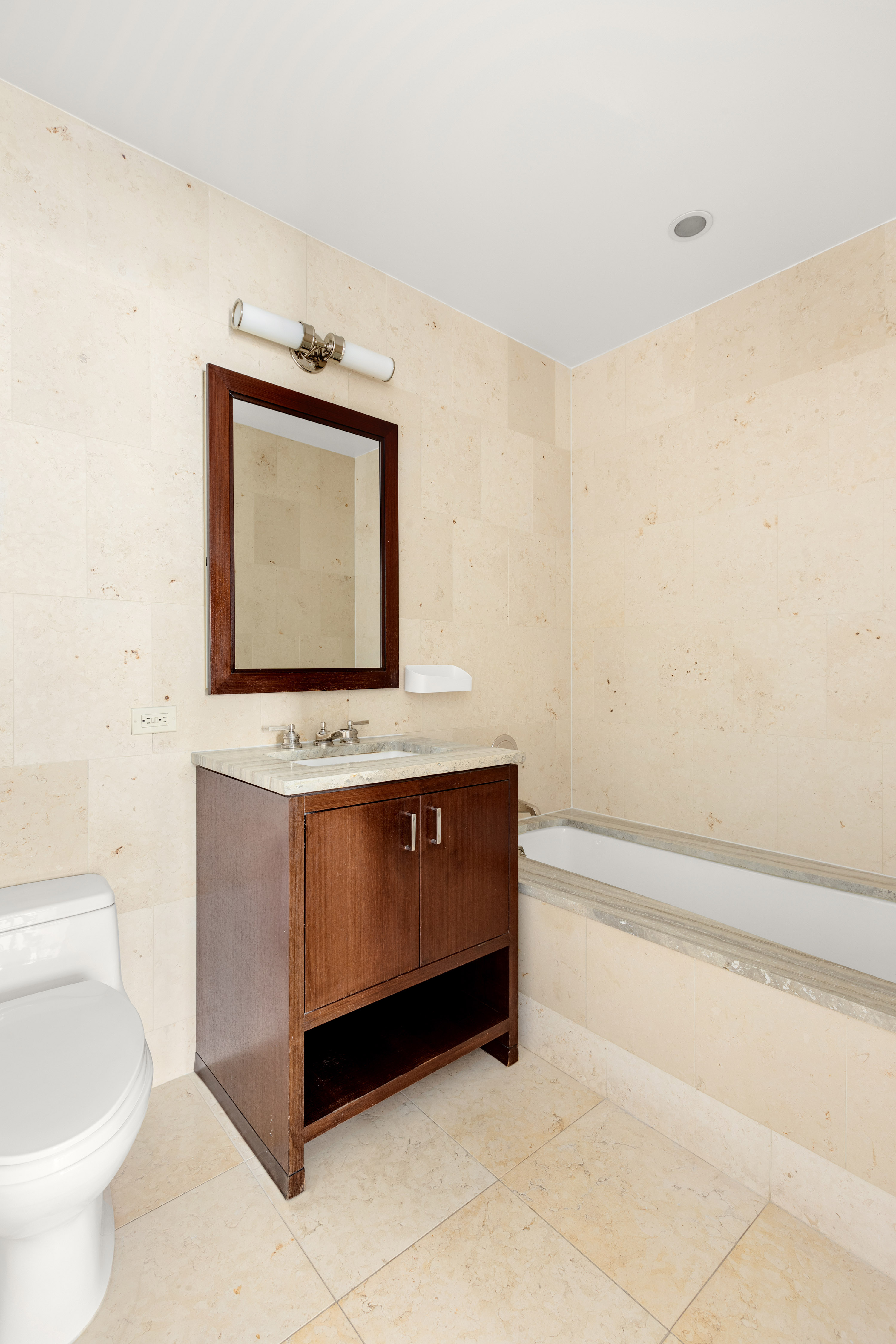 100 Riverside Boulevard, Unit 29C Manhattan, NY 10069 - Photo 7 of 15 a bathroom with a toilet sink and mirror