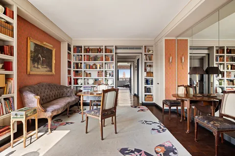 a living room with furniture and a bookshelf