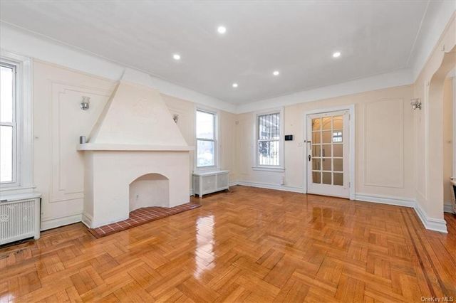 1186 Brooklyn Avenue, Unit N A Brooklyn, NY 11203 - Photo 4 of 17 a view of an empty room with a fireplace and a window