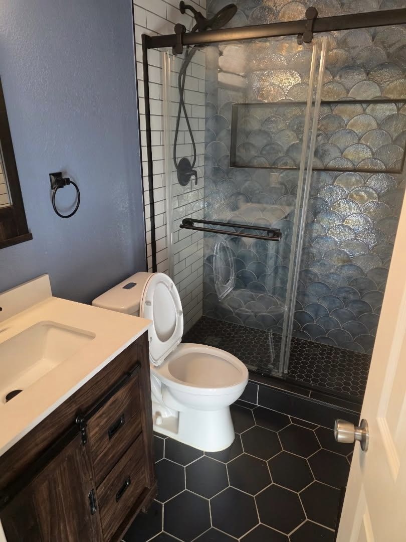 1672 South Rifle Street Aurora, CO 80017 - Photo 3 of 4 a bathroom with a toilet and a shower