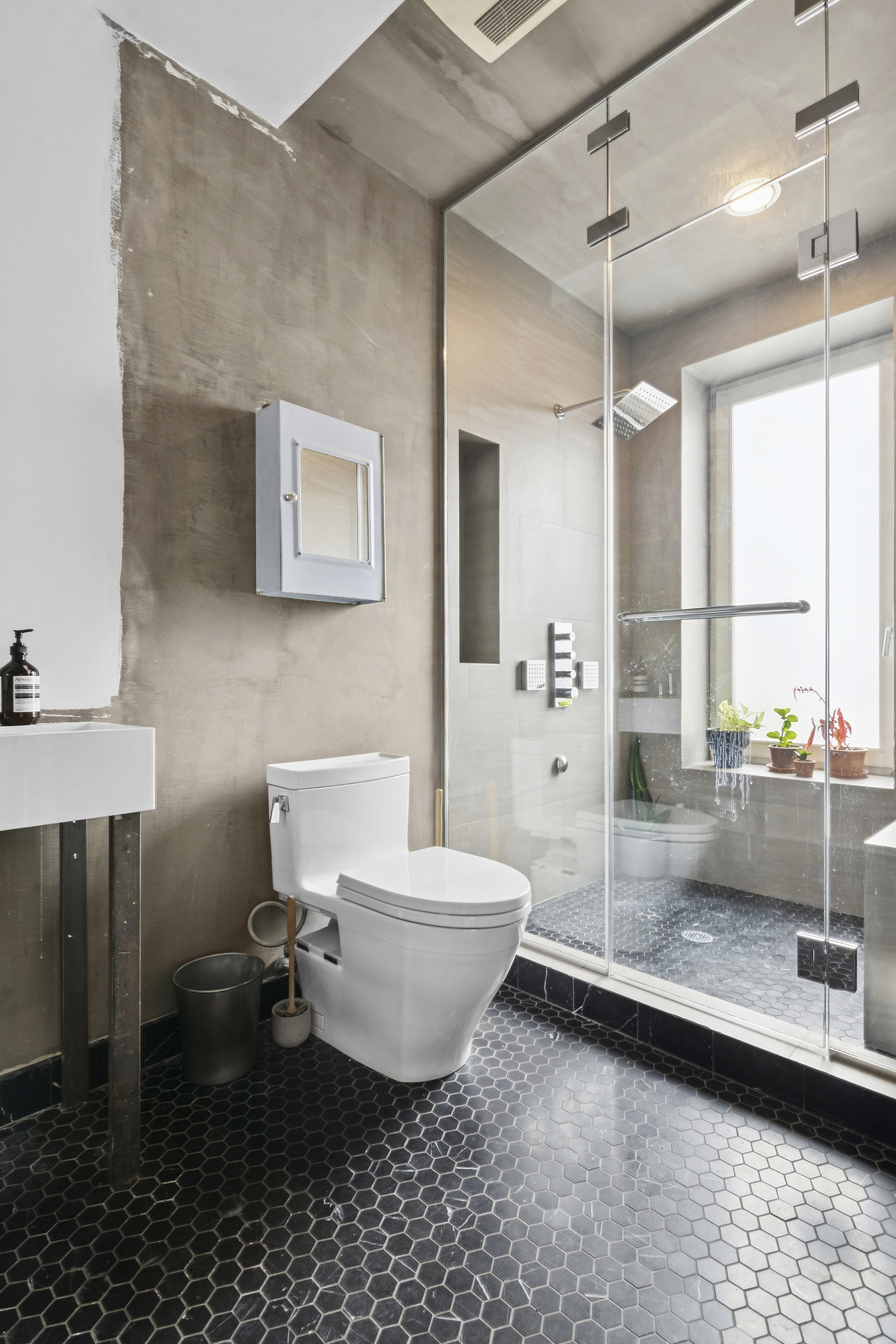 581 Greene Avenue, Unit 2 Brooklyn, NY 11216 - Photo 11 of 16 a bathroom with a toilet sink and mirror