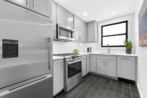 a kitchen with a sink stove and microwave