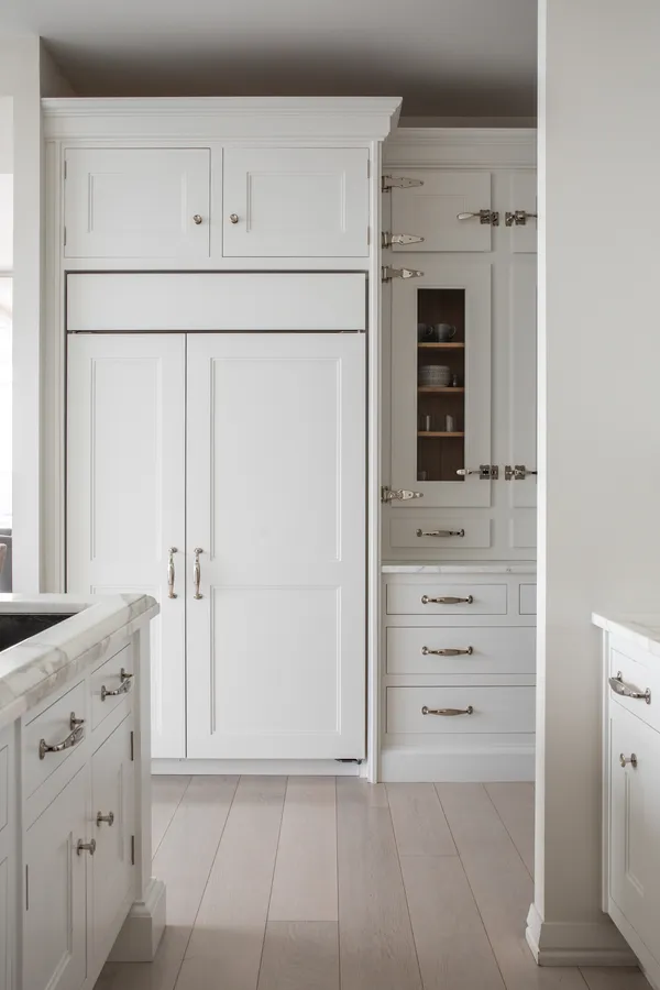 a white stove top oven sitting inside of white cabinets