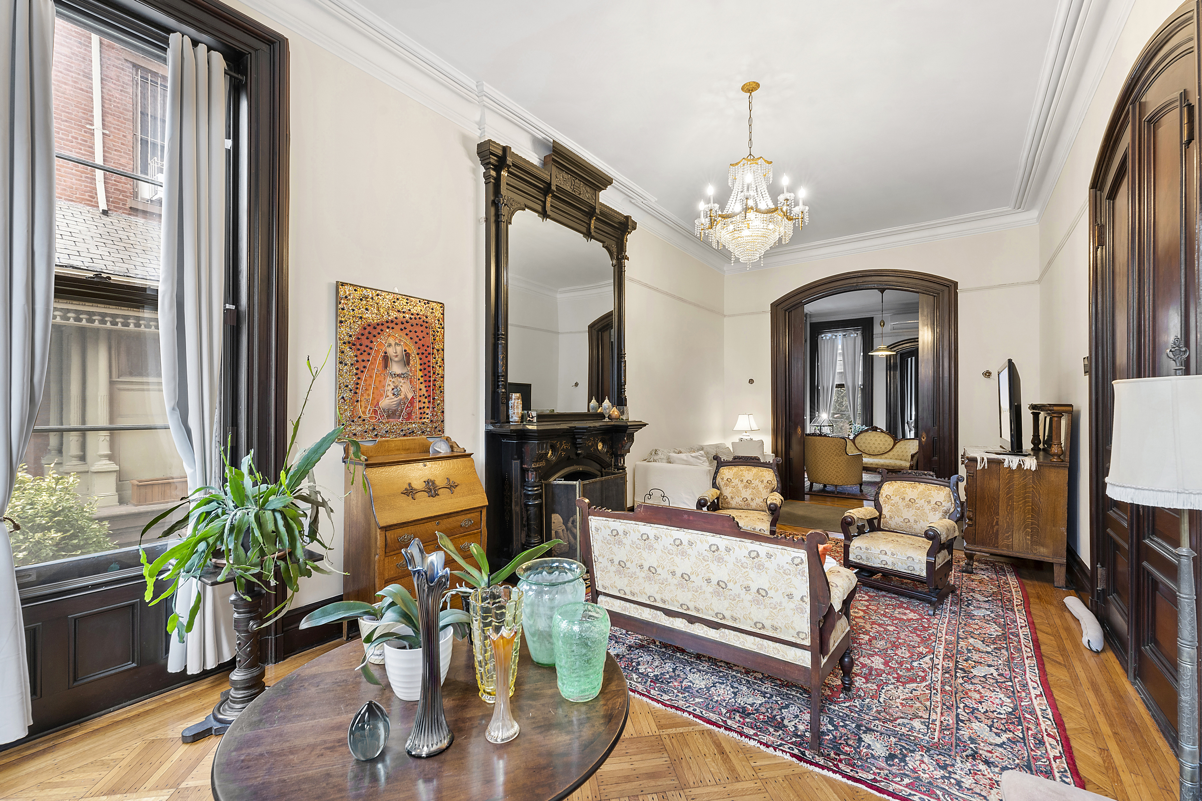 419 Clinton Avenue Brooklyn, NY 11238 - Photo 1 of 19 a living room with patio furniture dining table and a chandelier