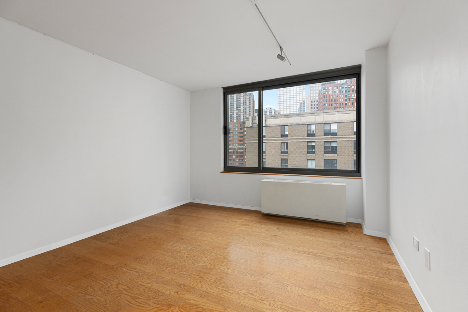 2 South End Avenue, Unit 8E Manhattan, NY 10280 - Photo 2 of 16 an empty room with large window