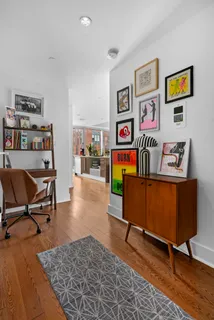 a living room with furniture and painting on the wall