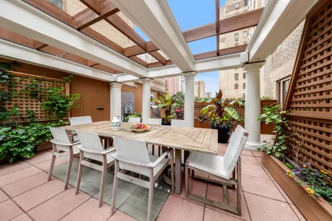 a view of an outside dining space with furniture