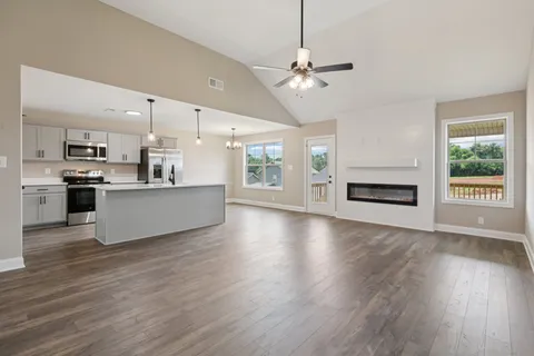 a view of a kitchen with a stove cabinets and a wooden floor