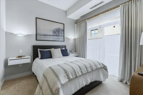 a bedroom with a bed and a painting on the wall