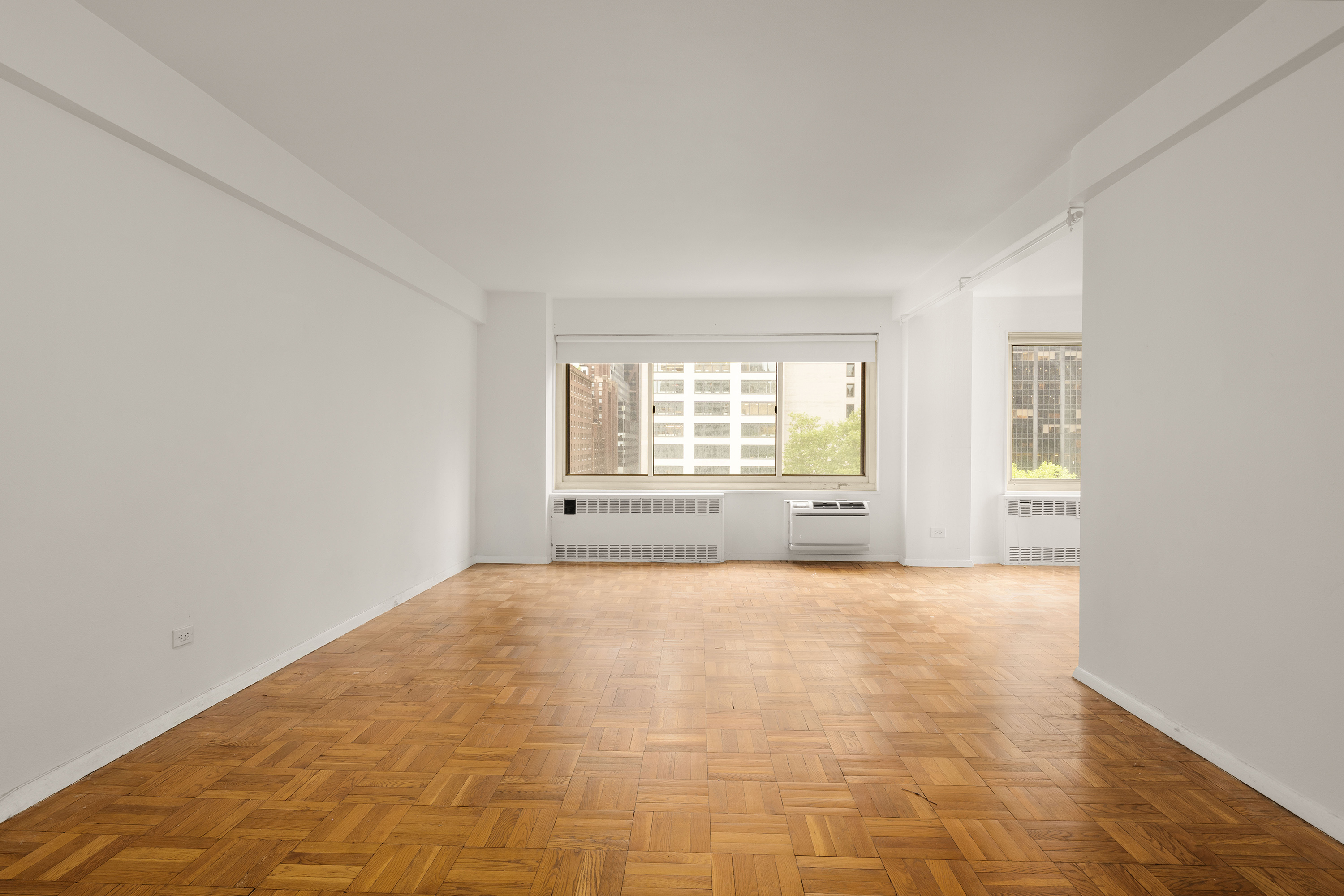 249 East 48th Street, Unit 12A Manhattan, NY 10017 - Photo 1 of 9 a view of an empty room with a window
