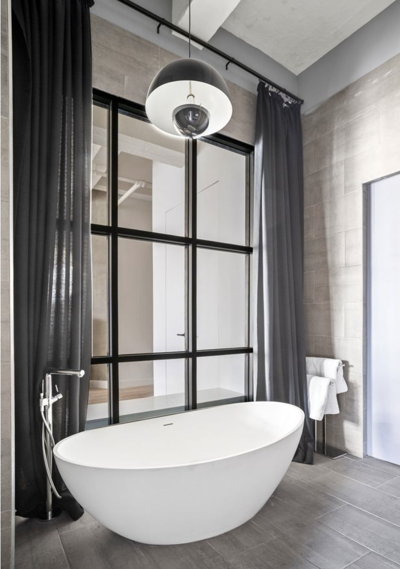 448 West 37th Street, Unit 8C Manhattan, NY 10018 - Photo 8 of 10 a view of a room with wooden floor and a chair