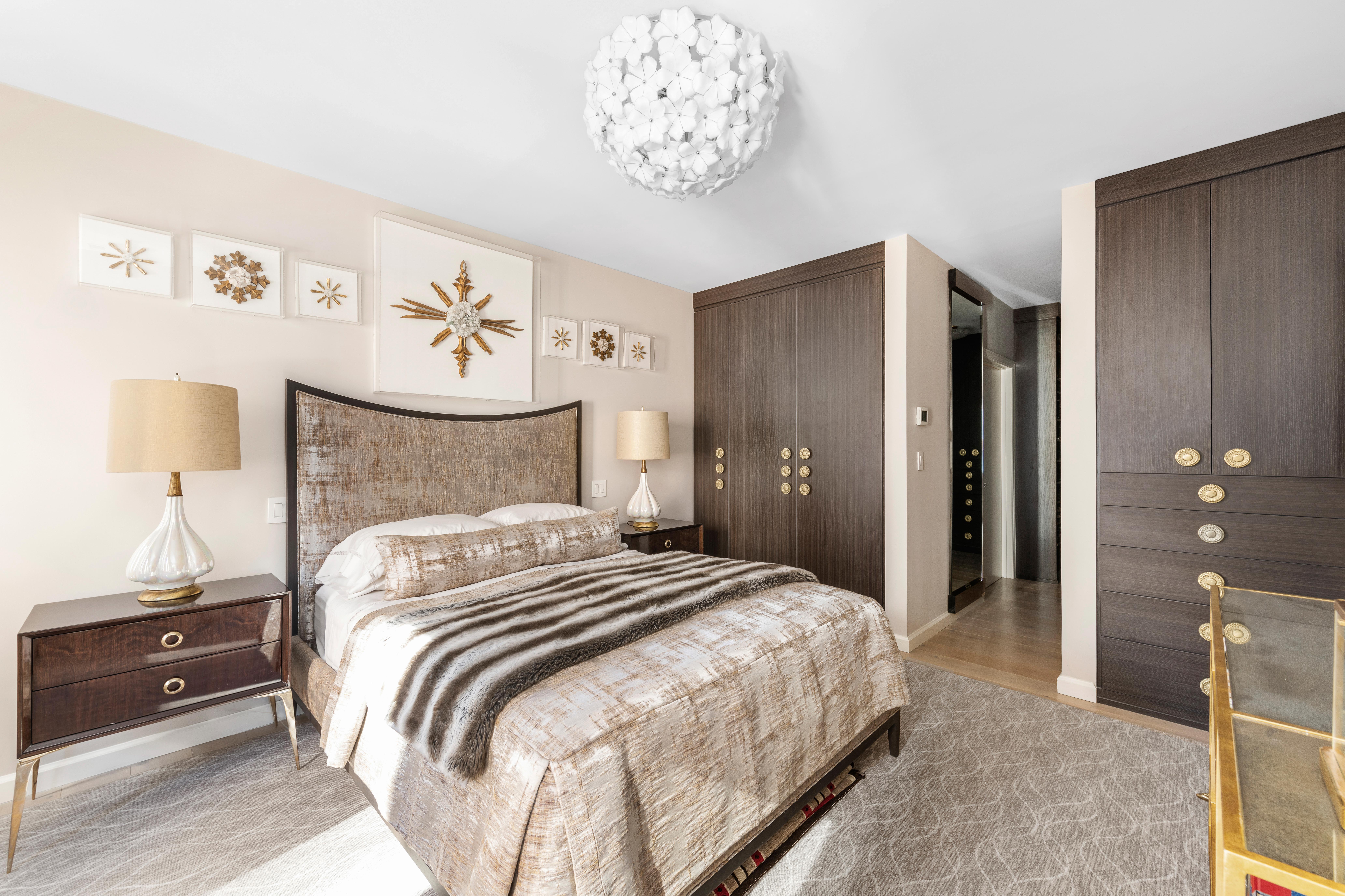 200 East 62nd Street, Unit 5A Manhattan, NY 10065 - Photo 11 of 25 a bedroom with a bed and a chandelier