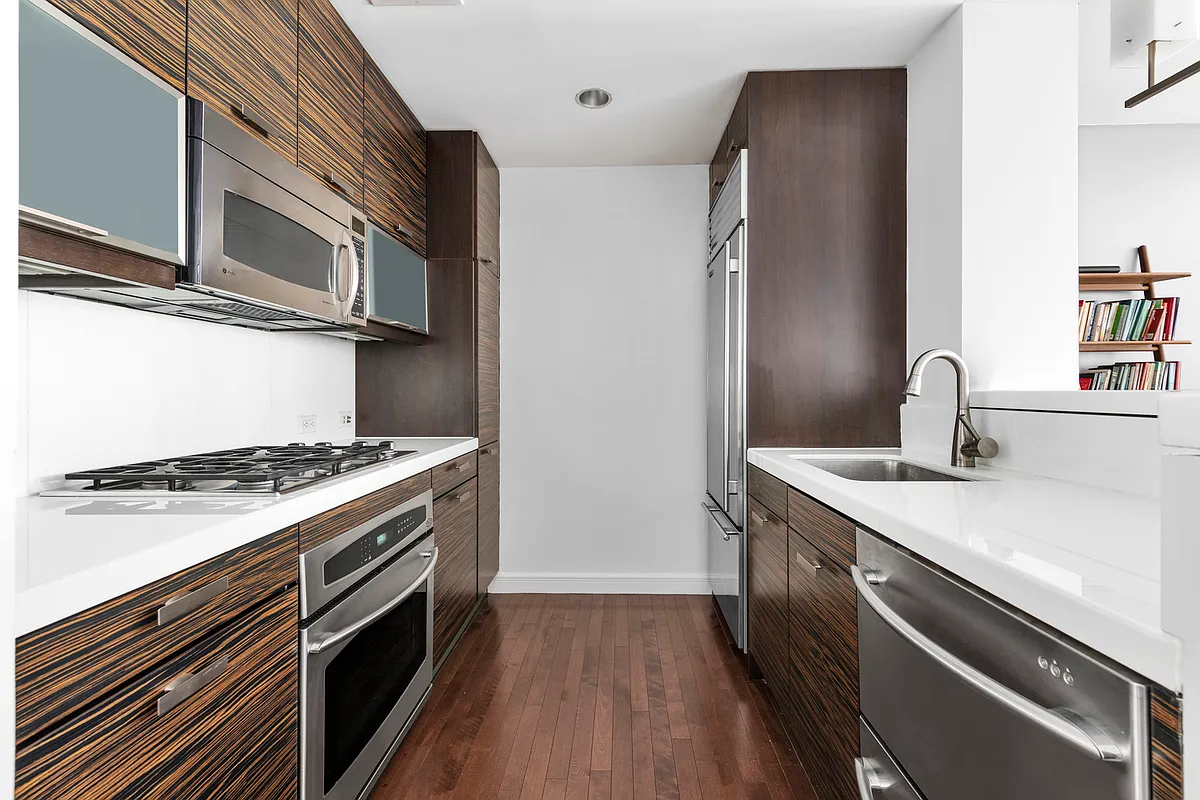 225 East 34th Street, Unit 8B Manhattan, NY 10016 - Photo 4 of 18 a kitchen with a stove and a refrigerator