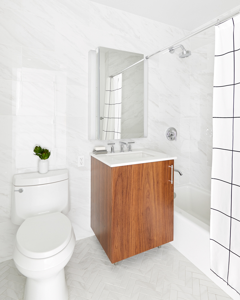 120 Nassau Street, Unit 18B Brooklyn, NY 11201 - Photo 4 of 12 a bathroom with a sink a toilet and shower