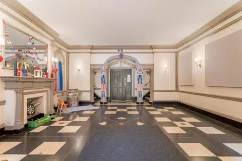 a view of a livingroom with fireplace and window