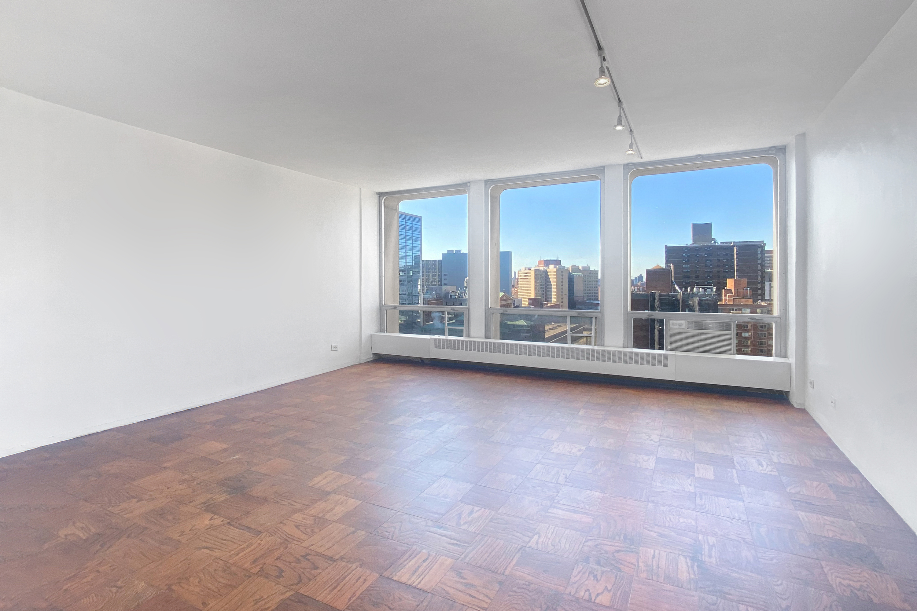 343 East 30th Street, Unit 19K Manhattan, NY 10016 - Photo 2 of 22 an empty room with floor to ceiling windows and outdoor view